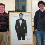 Will Meehan (left) and Spencer Torres stood next to a poster of tux model Clayton Straker. 